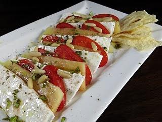 Carpaccio di giuncata, papaya e pomodoro datterino con pinoli e olio nuovo